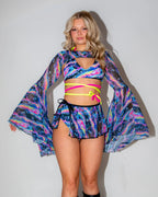 Acid Sky Mesh Bell Sleeves on a model, front view, showcasing the vibrant psychedelic pattern and flared bell sleeves, perfect for a rave festival.