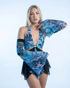 Glacial Metamorphosis Arm Sleeves on a model, front view, showcasing the cyan, blue, and lavender rave pattern.