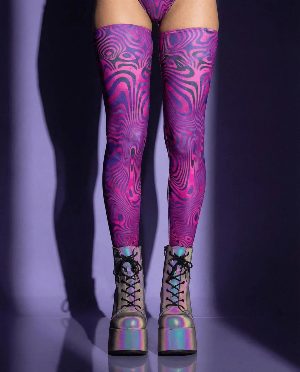 Vanish Leg Sleeves in a psychedelic pink and purple swirl pattern, shown from the front on a model, perfect for rave festivals.