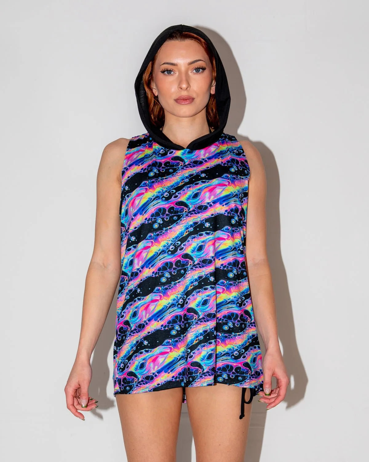 Acid Sky Men's Tank Top with Hood front view, featuring vibrant neon pink, blue, and purple swirls, perfect for a rave festival.