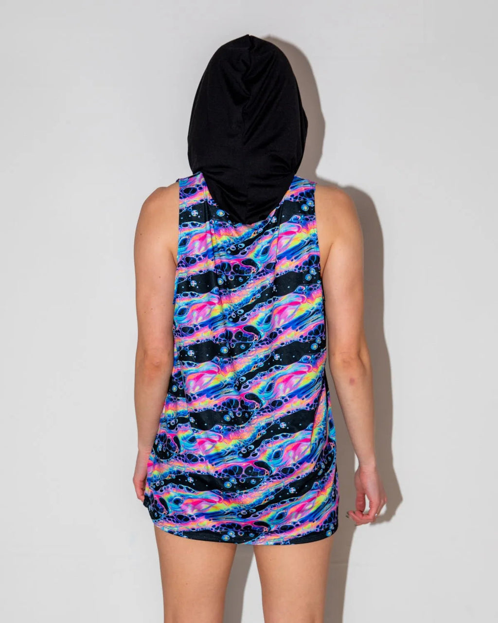 Acid Sky Men's Tank Top with Hood shown from the back, featuring vibrant neon pink, electric blue, and cosmic purple swirls, perfect for a rave festival.