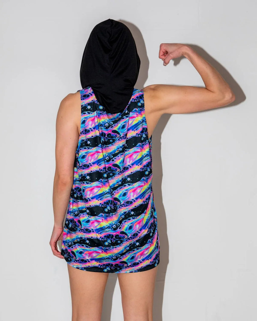 Acid Sky Men's Tank Top with Hood seen from the back, featuring vibrant neon pink, blue, and purple swirls, perfect for rave festivals.