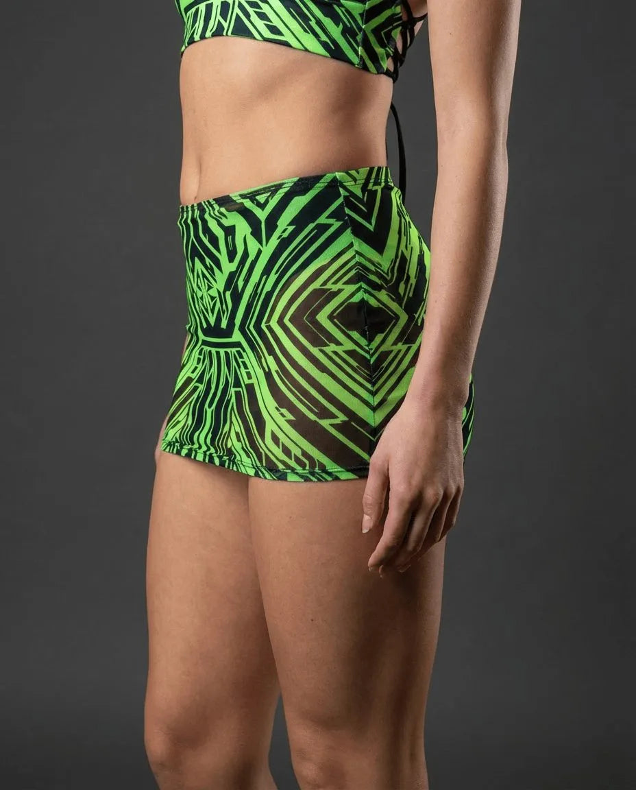 Neon green Techtronix rave skirt with geometric black pattern worn by model in side pose