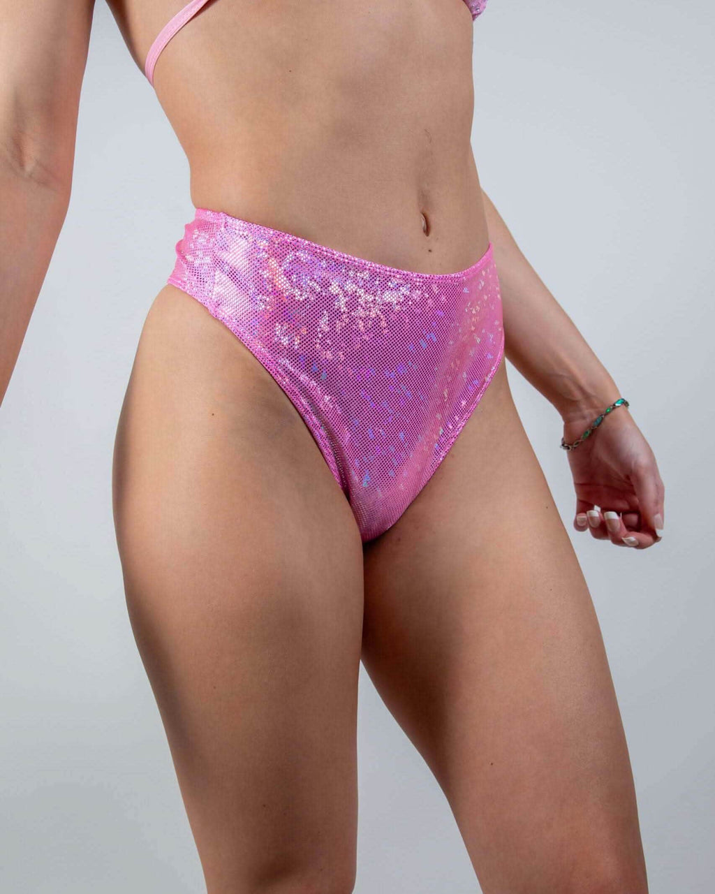 Bubble Gum Holo High Waisted Thong in iridescent pink, shown from the side, perfect rave festival bottoms.