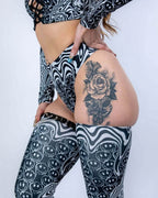 Meltdown High Waisted Thong in black and white melty smiley face print, side view on a model, perfect for rave festivals.