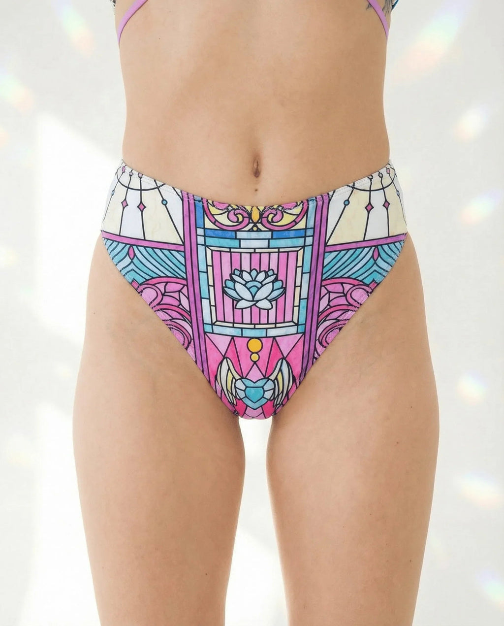 Moonlight High Waisted Thong in a vibrant stained-glass mosaic pattern, featuring magenta, cyan, and violet, worn by a model from the front, perfect for rave festivals.