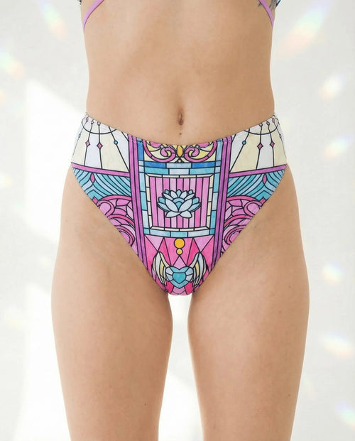 Moonlight High Waisted Thong in a vibrant stained-glass mosaic pattern, featuring magenta, cyan, and violet, worn by a model from the front, perfect for rave festivals.