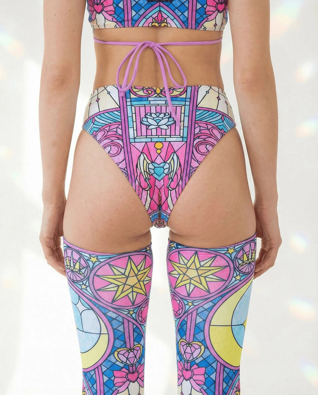 Moonlight High Waisted Thong and matching legwear from the back, featuring a vibrant pink, blue, and yellow stained-glass rave pattern.
