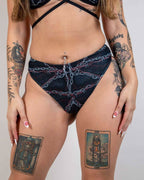 Purgatory High Waisted Thong in black with chain graphic, worn by a model facing front, perfect for a rebellious rave festival look.
