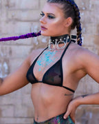 Black Mesh Bikini Top on a model, viewed from the side, showcasing the sheer fabric and daring festival style.