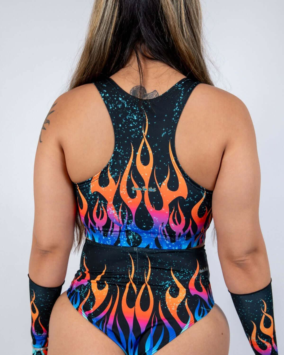 Back view of Blaze V Free rave top with colorful flame pattern and matching bottoms for festival outfits