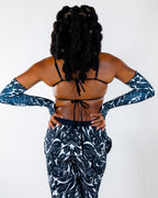 BLVDE Wonder Top shown from the back, featuring a black bikini-style top with ties and matching black and white patterned long sleeves and pants, ideal for festival wear.