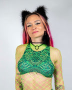 Dominion Teaser Top in green with intricate patterns, worn by a woman in a neon green fishnet top, front view, perfect for rave festivals.