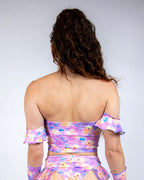 Back view of Duckies Bardot rave top in purple pink yellow print showing off-shoulder festival outfit styling