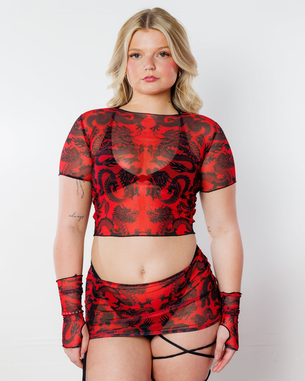 Dynasty Baby Tee in red, a sheer mesh rave top with black dragon print, worn by a model facing front.
