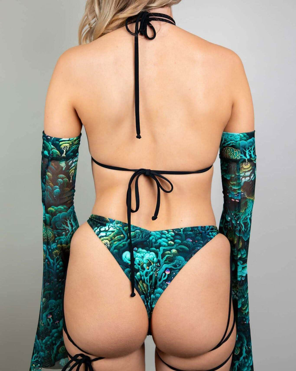 Faewood strappy rave top back view showing teal forest print with black tie details and matching arm sleeves