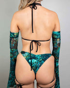 Faewood strappy rave top back view showing teal forest print with black tie details and matching arm sleeves