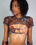 Woman modeling brown orange Fossil mesh rave top with chest cutout design for festival outfit styling