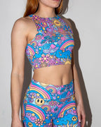 Groovy Slit Crop Top front view, featuring a vibrant psychedelic rainbow pattern, perfect for rave and festival wear.