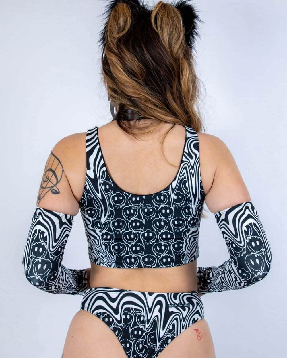 Back view of Meltdown rave top with trippy black white swirled smiley face pattern and matching arm sleeves