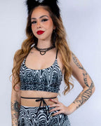 Meltdown psychedelic rave top with swirled smiley face print modeled against white background for festival outfit styling