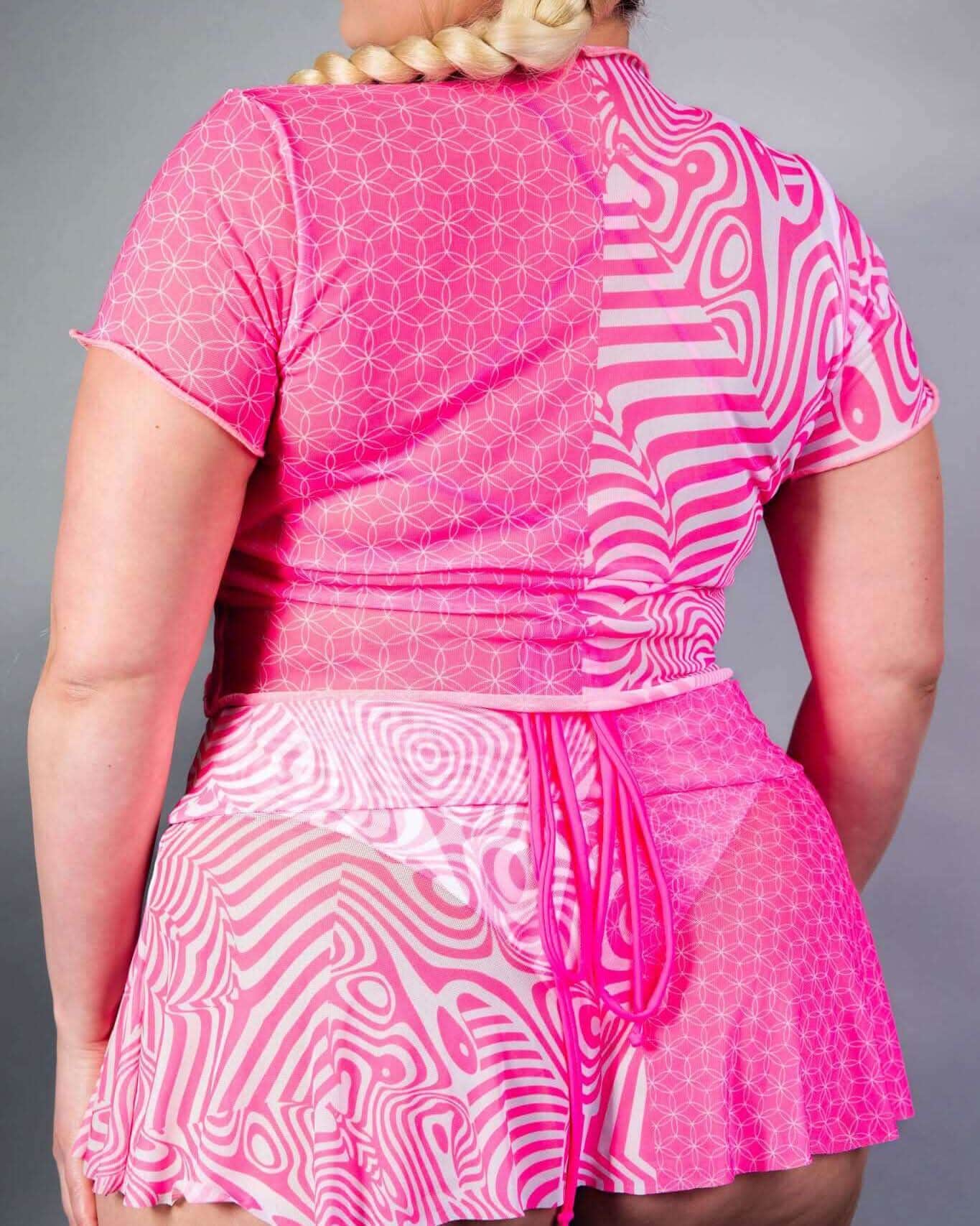 Back view of pink Electricity mesh rave top with geometric patterns and flowing design details