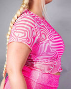 Pink electricity mesh rave top with swirled pattern shown in side view for festival outfit styling