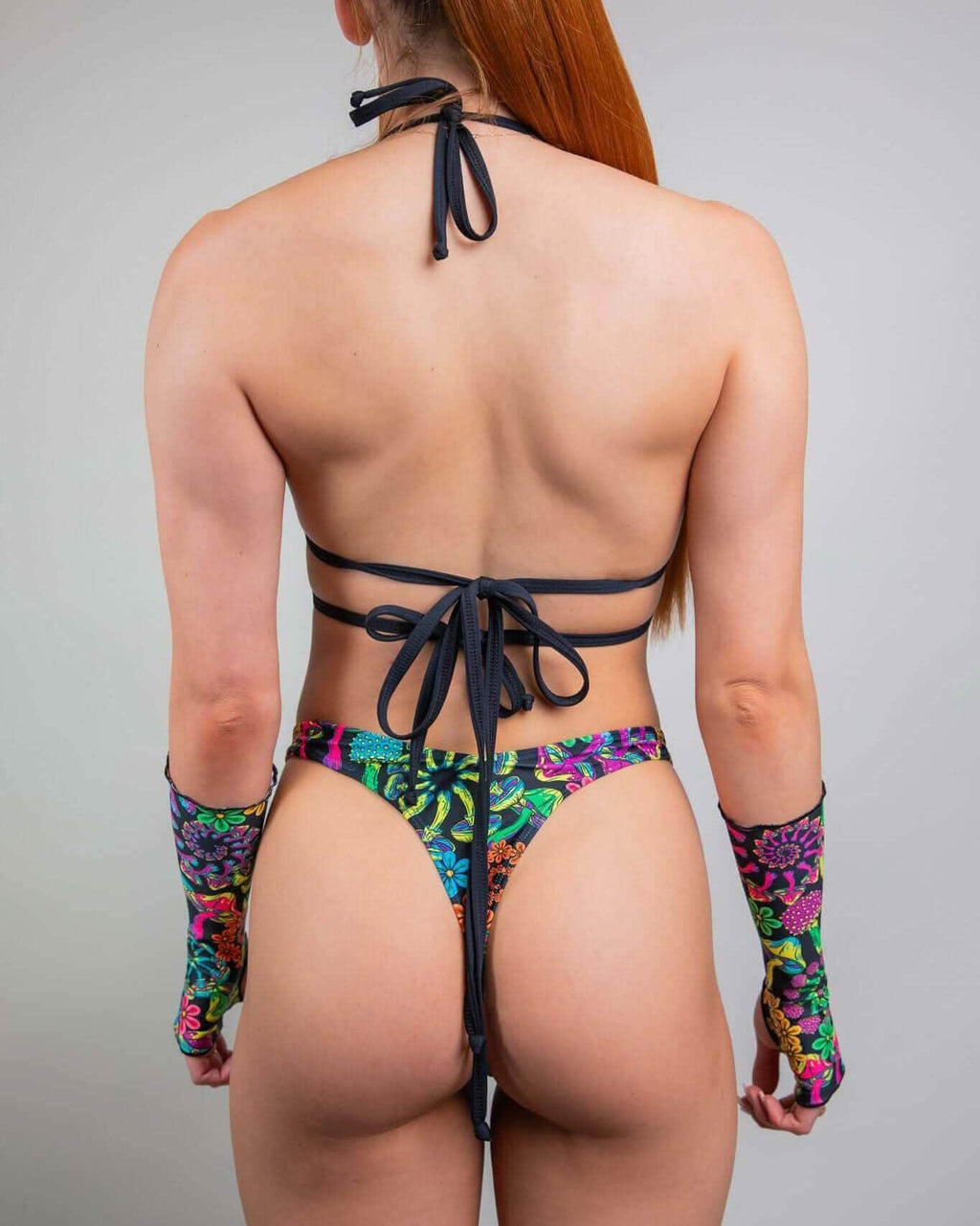 Back view of PsyBloom psychedelic print rave top and matching bikini bottom with colorful festival pattern