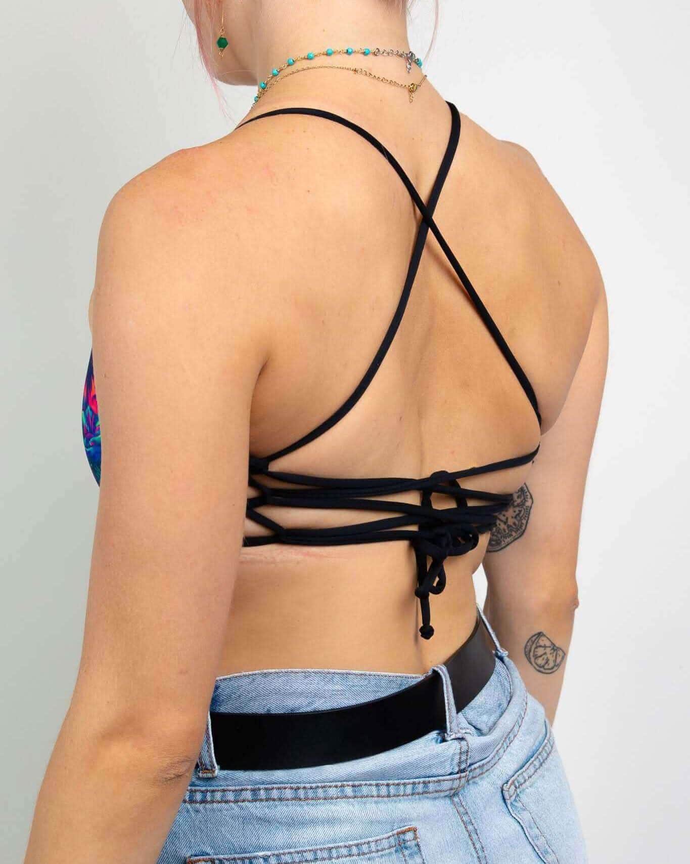 Back view of Saurian reversible rave top showing intricate strappy tie design and adjustable fit