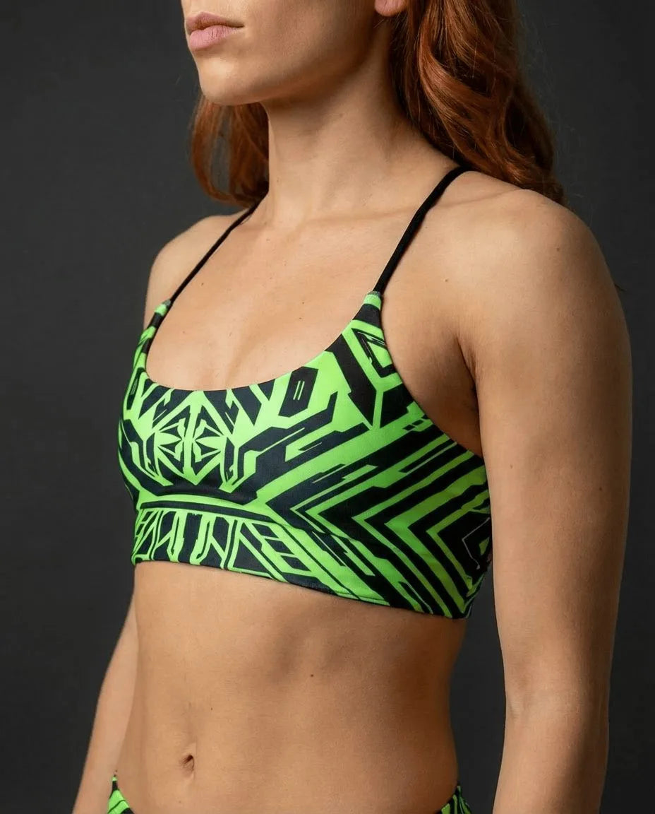 Techtronix Lush Top in neon green and black, featuring a cyber-tribal geometric pattern, worn by a model from the side, perfect for rave festivals.