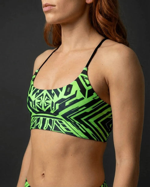 Techtronix Lush Top in neon green and black, featuring a cyber-tribal geometric pattern, worn by a model from the side, perfect for rave festivals.