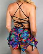 Back view of Vivid Shroomie reversible rave top with black lace-up strappy detail and psychedelic rainbow print