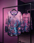 Fairycore hockey jersey in pink purple gradient with wildflower mystical print hanging on rack festival rave wear