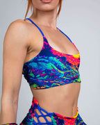 Colorful Saurian reversible rave top in neon tropical print - front view festival outfit on model