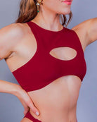 Model showcasing the Scarlet Cutout Teaser Top, a sultry underboob top perfect for rave outfits.