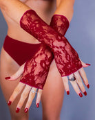 Scarlet lace gloves showcased with a model in a bikini, perfect for rave outfits and sultry fashion.