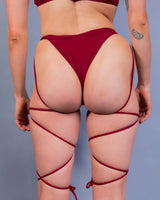 Scarlet strappy bikini bottoms with bold cutouts, perfect for rave outfits and making a statement.
