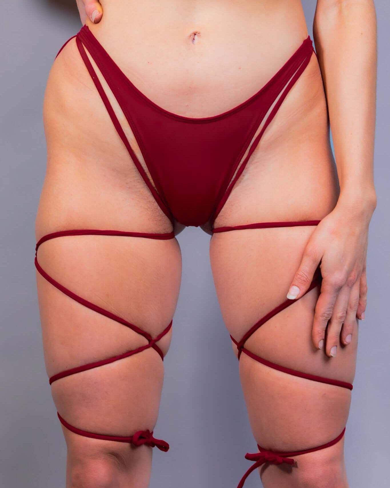 Scarlet strappy high hip bikini bottoms styled for rave outfits, showcasing a sultry design and cheeky cut.
