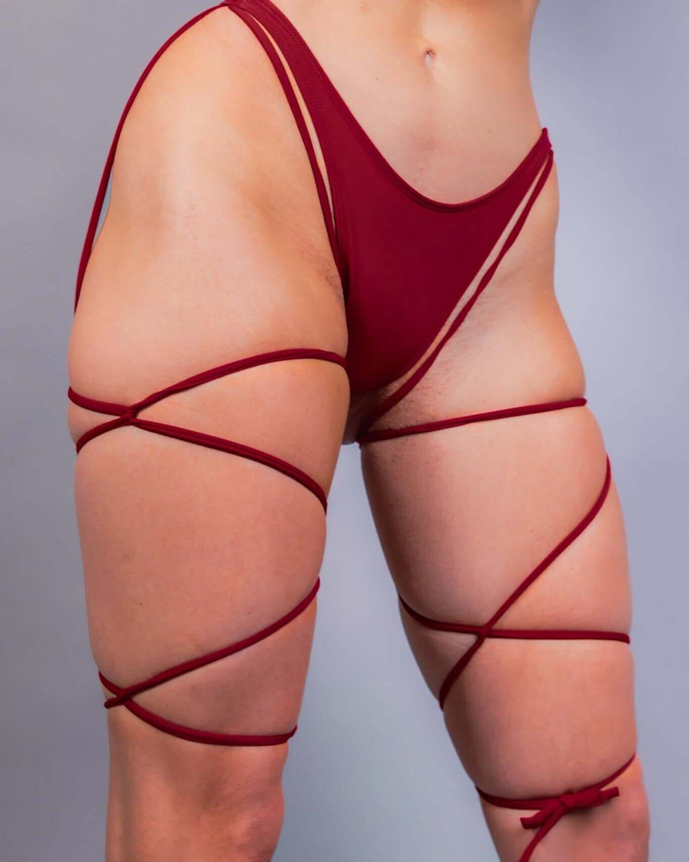 Scarlet strappy bikini bottoms with bold straps, perfect for rave outfits and stylish summer wear.