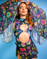 Model wearing Shroomie! Mesh Bell Sleeves with vibrant patterns, showcasing a trippy rave outfit against a blue background.