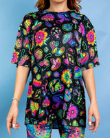 Oversized Shroomie tee with vibrant mushroom and floral print, perfect for rave outfits and ultimate comfort.