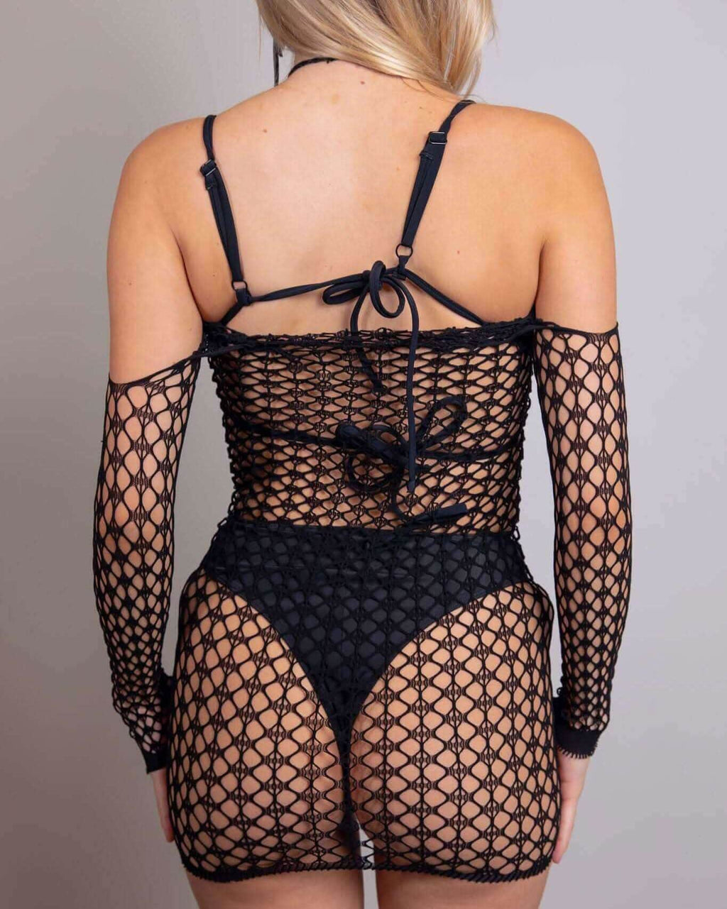 Back view of Tie It Up Halter Fishnet Dress, featuring sheer fishnet material and off-the-shoulder design, perfect for rave outfits.