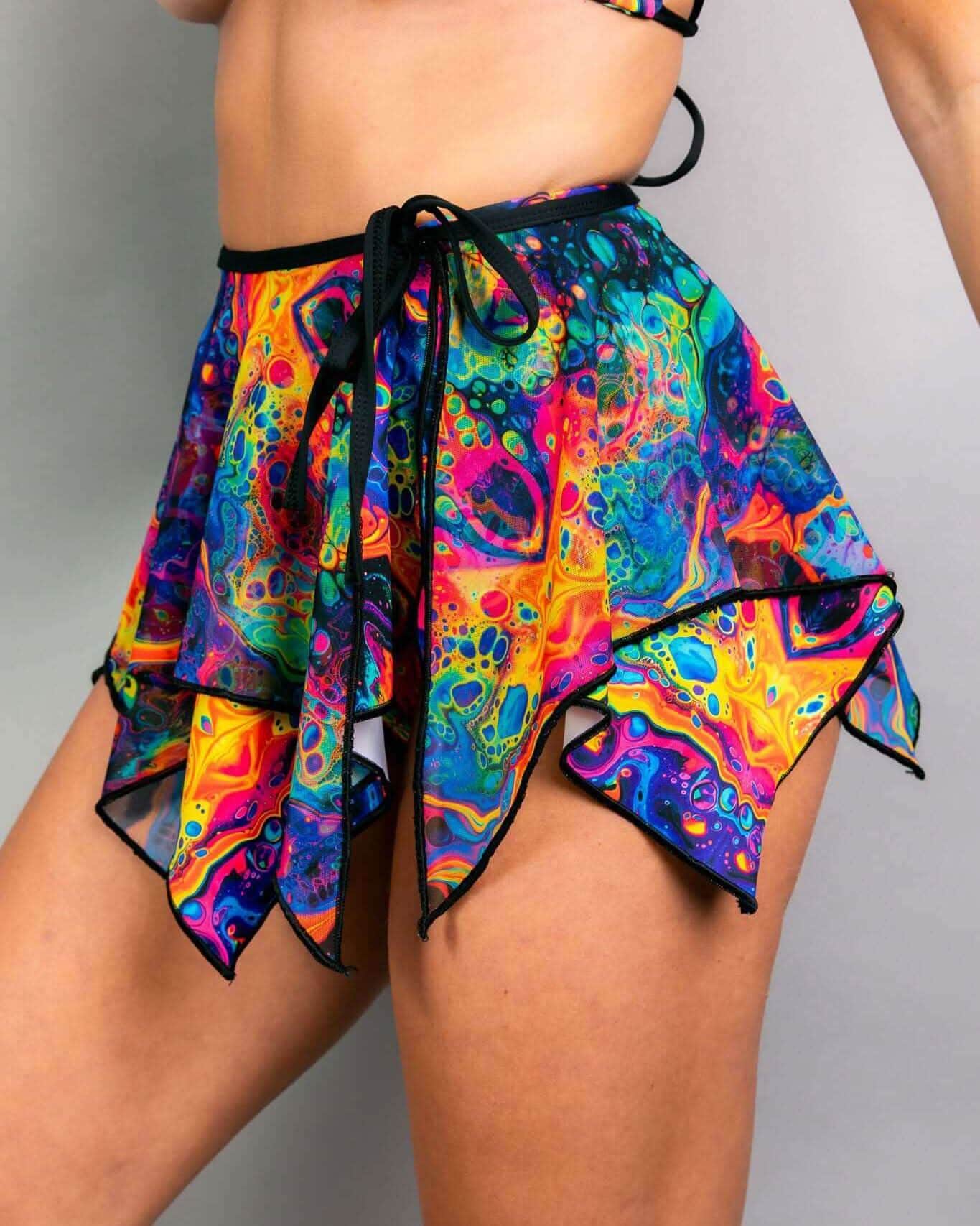 Vivid psychedelic rave skirt with rainbow handkerchief hem and tie waist, festival fashion front view
