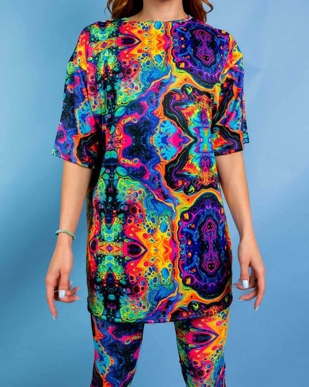 Model wearing Vivid Oversized Softee in vibrant rainbow fabric, perfect for stylish rave outfits.