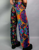 Vibrant rainbow mesh Lucy pants showcased from behind, perfect for rave outfits and festivals.