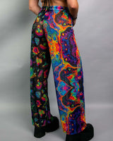 Vibrant rainbow mesh Lucy pants showcased from behind, perfect for rave outfits and festivals.
