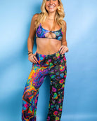 Model showcasing Vivid Shroomie! Mesh Lucy Pants and matching bikini top, perfect for rave outfits and festivals.