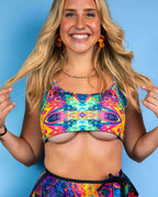 Blonde model wearing Vivid Shroomie psychedelic rainbow rave top crop style festival outfit front view