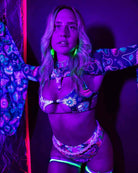Model in vibrant rave outfit with psychedelic patterns and glow accessories under neon lights. Perfect for festival wear.