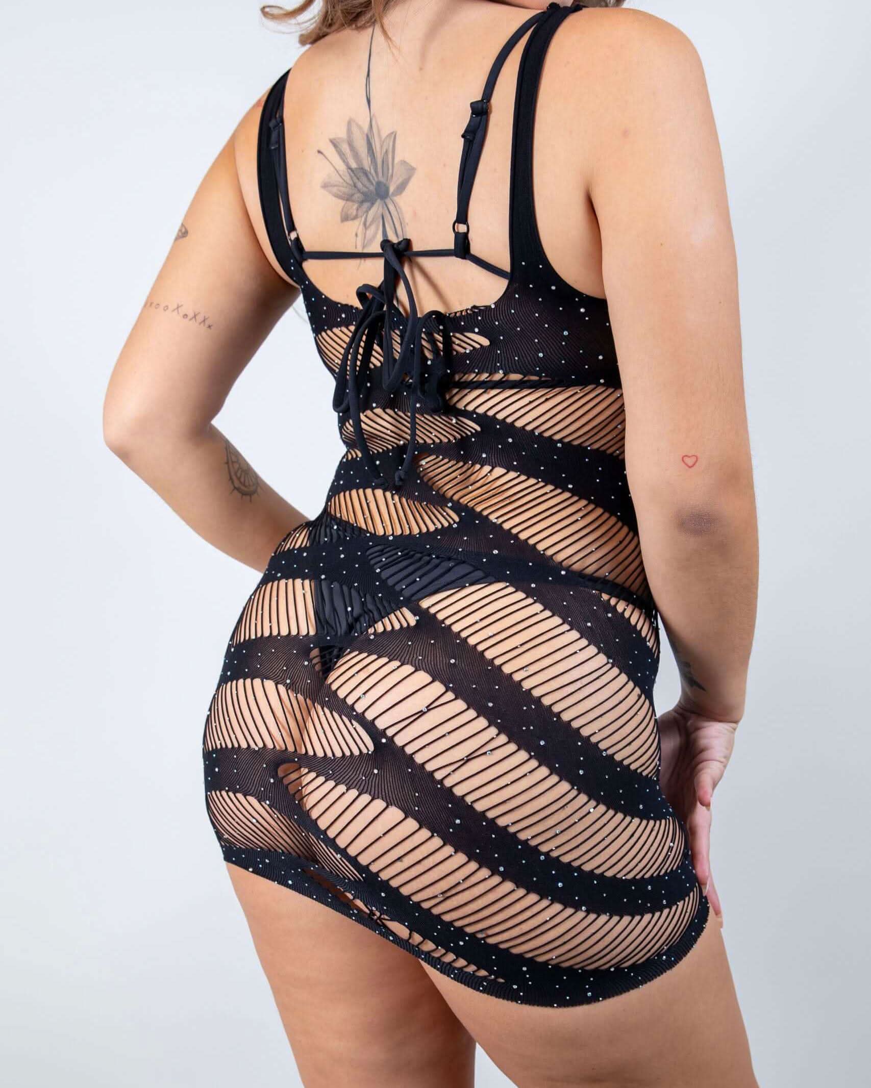 Black rave bodysuit fishnet dress back view showing strappy harness design and rhinestone details for festival wear